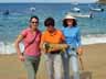 [Three females holding iguana]